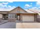 Inviting exterior showcasing a two-car garage and charming stone accents at 23590 E Jamison Pl, Aurora, CO 80016