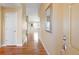 Bright hallway featuring wood floors, neutral paint and access to main living areas at 23590 E Jamison Pl, Aurora, CO 80016