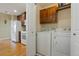 The laundry room is conveniently located with cabinets and appliances next to the kitchen at 23590 E Jamison Pl, Aurora, CO 80016