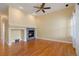 Spacious living room featuring a cozy fireplace and wood flooring at 23590 E Jamison Pl, Aurora, CO 80016