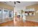 Open living area with hardwood floors, modern lighting, and a breakfast bar at 23590 E Jamison Pl, Aurora, CO 80016
