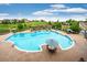 Resort-style swimming pool with plenty of seating, mature landscaping, and ample deck space at 23590 E Jamison Pl, Aurora, CO 80016