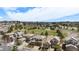 Panoramic aerial showcases a neighborhood with manicured lawns, mature trees, a green park, and a community pool at 7004 S Addison Ct, Aurora, CO 80016