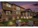 Inviting backyard patio features a covered porch with outdoor seating and a fire pit area for entertaining at 7004 S Addison Ct, Aurora, CO 80016