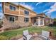 Inviting backyard with a stone and siding home, a covered patio, and outdoor fire pit area at 7004 S Addison Ct, Aurora, CO 80016