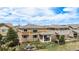 Charming backyard featuring a covered patio, lush green lawn, and comfortable outdoor seating area at 7004 S Addison Ct, Aurora, CO 80016