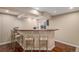 Finished basement wet bar with three seats and tile countertop, perfect for entertaining at 7004 S Addison Ct, Aurora, CO 80016
