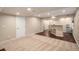 Finished basement featuring carpet, hardwood floors, a bar with stools, and neutral walls at 7004 S Addison Ct, Aurora, CO 80016