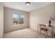 Bright bedroom featuring neutral walls, a large window, and a desk with a chair at 7004 S Addison Ct, Aurora, CO 80016