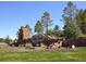 Stone entrance to a planned community with attractive landscaping and mature trees at 7004 S Addison Ct, Aurora, CO 80016