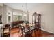 Elegant dining room with beautiful wood floors, large windows, and classic furniture at 7004 S Addison Ct, Aurora, CO 80016