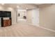 Finished basement Gathering room with big screen TV and access to additional rooms at 7004 S Addison Ct, Aurora, CO 80016