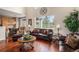 Bright and airy living room with hardwood floors, comfortable seating, and large windows with views of the outdoors at 7004 S Addison Ct, Aurora, CO 80016