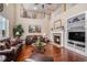 Soaring living room features a fireplace, hardwood floors, and an open floor plan with lots of natural light at 7004 S Addison Ct, Aurora, CO 80016