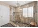 Modern glass shower featuring tile walls, a window, and a pebble floor at 7004 S Addison Ct, Aurora, CO 80016