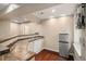 This finished basement wet bar includes a sink, storage and stainless steel refrigerator at 7004 S Addison Ct, Aurora, CO 80016