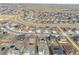 An aerial view shows a neighborhood featuring modern homes with solar panels on some roofs at 8388 E 132Nd Pl, Thornton, CO 80602