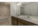 Modern bathroom boasts double sinks, contemporary fixtures, and a shower/tub combo with neutral color palette at 8388 E 132Nd Pl, Thornton, CO 80602