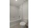 Bright bathroom featuring a white tub with tile surround and modern fixtures at 8388 E 132Nd Pl, Thornton, CO 80602
