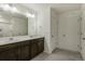 Bathroom with double sink vanity with a large mirror and modern fixtures in a neutral color palette at 8388 E 132Nd Pl, Thornton, CO 80602
