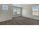Bright bedroom with neutral walls, multiple windows offering natural light, and plush carpet flooring at 8388 E 132Nd Pl, Thornton, CO 80602