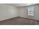 Neutral bedroom with large window and plush carpet, providing comfort at 8388 E 132Nd Pl, Thornton, CO 80602