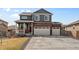 Beautiful two-story home boasting a brick facade, two-car garage, and inviting front porch at 8388 E 132Nd Pl, Thornton, CO 80602