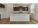 Modern kitchen featuring dark cabinets, a white island, stainless appliances at 8388 E 132Nd Pl, Thornton, CO 80602