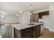 Spacious kitchen island with stainless steel dishwasher and modern finishes at 8388 E 132Nd Pl, Thornton, CO 80602