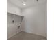 Functional laundry room with shelving and utility hookups for convenience at 8388 E 132Nd Pl, Thornton, CO 80602