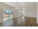 Open-concept living area with sliding glass doors to the outside and wood style flooring at 8388 E 132Nd Pl, Thornton, CO 80602