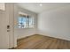 Bright living room with wood floors and large window, providing lots of natural light at 8388 E 132Nd Pl, Thornton, CO 80602
