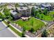 Aerial view of a home with lush lawn, stone patio, fenced yard, mature trees and solar panels at 16069 Pikes Peak Dr, Broomfield, CO 80023