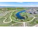 Scenic aerial view of a neighborhood featuring a pond, green spaces, walking paths, and residential homes at 16069 Pikes Peak Dr, Broomfield, CO 80023