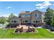 Large backyard and stone patio with a well-manicured lawn, perfect for outdoor entertaining at 16069 Pikes Peak Dr, Broomfield, CO 80023