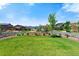 Expansive backyard with well-manicured lawn and a split-rail fence, perfect for outdoor activities at 16069 Pikes Peak Dr, Broomfield, CO 80023