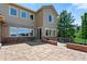 Back exterior showing stone patio, siding, and fenced yard in a residential neighborhood at 16069 Pikes Peak Dr, Broomfield, CO 80023
