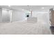 Large finished basement with neutral walls, carpet, and light wood flooring near a partial wall at 16069 Pikes Peak Dr, Broomfield, CO 80023