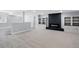 Spacious carpeted basement with a modern fireplace and custom built-in shelving at 16069 Pikes Peak Dr, Broomfield, CO 80023