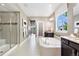 Beautiful bathroom features a tub, shower, double vanity and sleek tile at 16069 Pikes Peak Dr, Broomfield, CO 80023