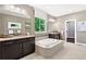 An elegant bathroom boasts a soaking tub, dual vanities, and a walk-in shower at 16069 Pikes Peak Dr, Broomfield, CO 80023