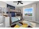 A bedroom with bunk beds, a colorful rug and lots of natural light at 16069 Pikes Peak Dr, Broomfield, CO 80023
