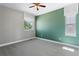 Bright bedroom with neutral walls, a ceiling fan, and large windows providing natural light at 16069 Pikes Peak Dr, Broomfield, CO 80023