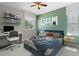Bright bedroom featuring a ceiling fan, comfortable bed, floating shelves, desk and fun decor at 16069 Pikes Peak Dr, Broomfield, CO 80023