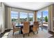 This dining room features a large table, picture windows and access to the outdoor patio at 16069 Pikes Peak Dr, Broomfield, CO 80023