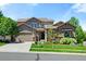 Charming two-story home featuring a well-maintained front yard, two car garage, and inviting curb appeal at 16069 Pikes Peak Dr, Broomfield, CO 80023