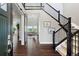 Spacious foyer featuring hardwood floors, staircase and view into the living room at 16069 Pikes Peak Dr, Broomfield, CO 80023