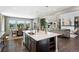 Gourmet kitchen with large island, stainless steel appliances, dark wood cabinets and open concept living at 16069 Pikes Peak Dr, Broomfield, CO 80023
