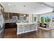 Modern kitchen with stainless steel appliances, a large island, and adjacent dining area at 16069 Pikes Peak Dr, Broomfield, CO 80023