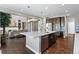 This gourmet kitchen boasts stainless appliances, island with sink, and breakfast bar with an open floorplan at 16069 Pikes Peak Dr, Broomfield, CO 80023